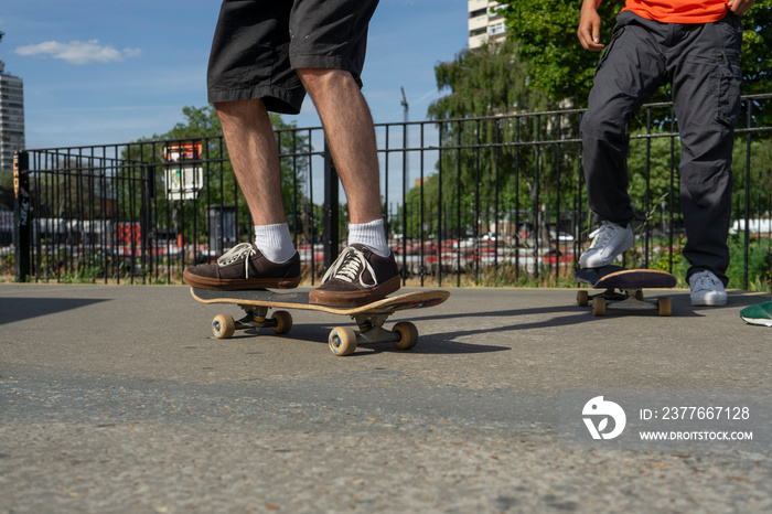 Young men skateboarding in skate park