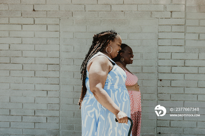 2 plus size African American women walk outside