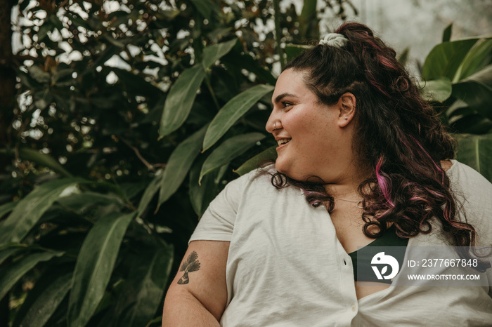 close up portrait of plus size woman smiling and looking off