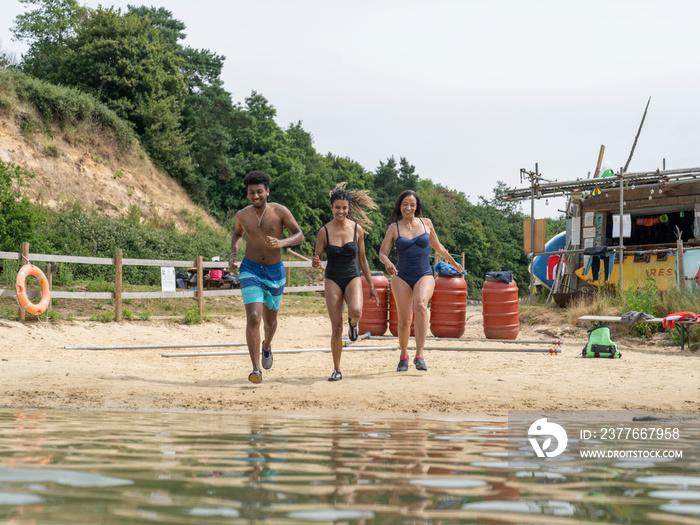 Friends running into lake