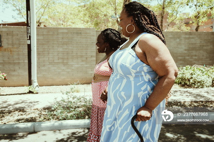 2 African American women walk down the street