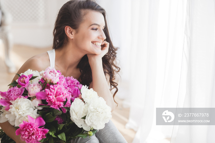 Young attractive woman with flowers