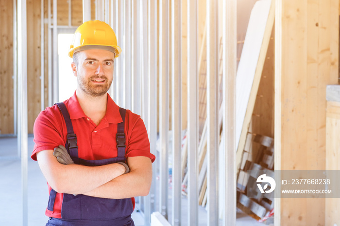 Portrait of smiling worker on building site background