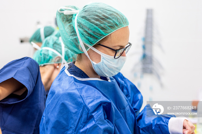 Covid-19. Female nurse puts on protective gloves. Personal protective equipment in the fight against Coronavirus disease .