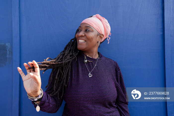 Portrait of beautiful woman with dreadlocks wearing turban