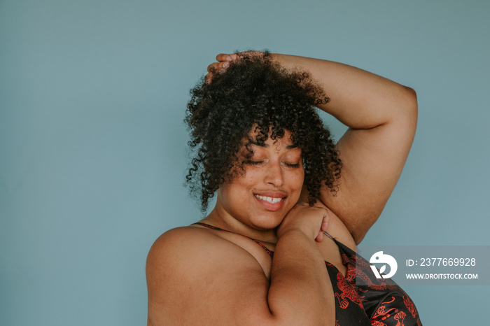 closeup protrait of a plus size afro indigenous person looking down eyes closed