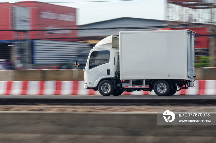 Motion image of a small white truck for road running transportation