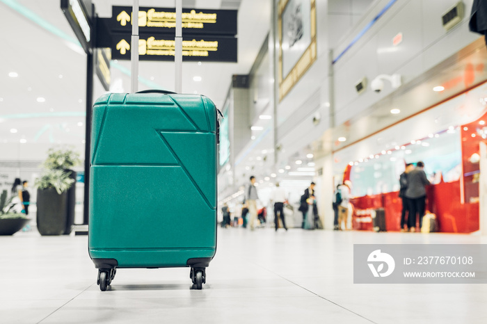 Suitcases in airport departure terminal with traveler people walking in background,Holiday vacation concept, Business trip,selective focus on suitcases