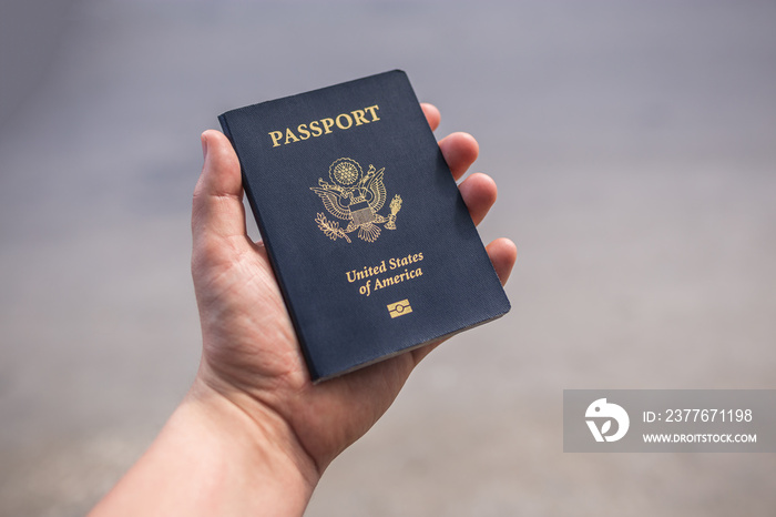 Holding a blue American passport