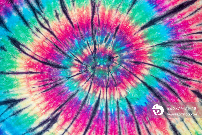 spiral tie dye pattern hand dyed on cotton fabric abstract texture background.