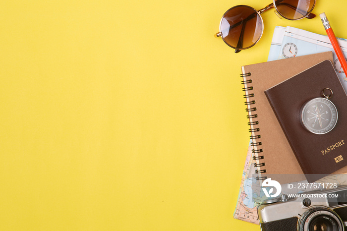 Traveler accessories on yellow background with camera and sunglasses. Top view travel or vacation concept. Flat lay, top view. Summer background.