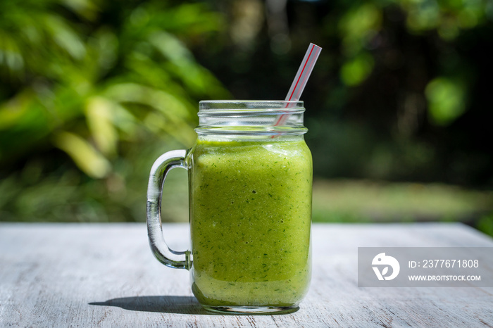 Fresh smoothies from avocado, banana, mango and honey in white wooden table