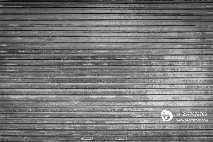 Old weathered and rusty corrugated steel door for steel metal backgroud and texture.