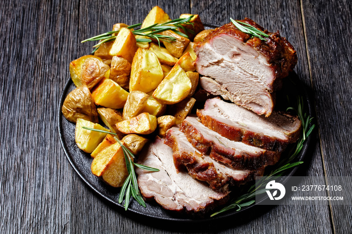 Whole roasted pork loin with baked potato wedges