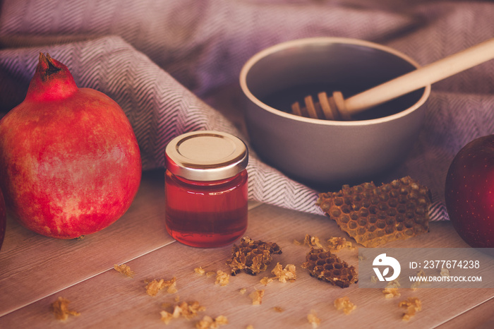 Jewish National Holiday. Rosh Hashana with honey, apple and pomegranate on wooden table.