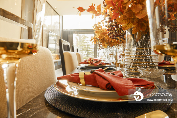 Table setting with autumn decorations, glasses and plates. Holidays, catering and hospitality concept.