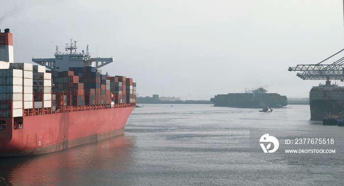 Large container ships leaving the port during dense traffic