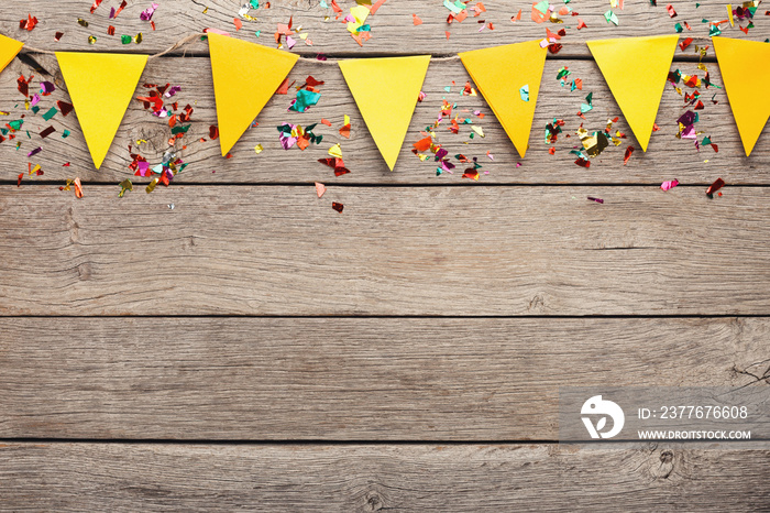 Colorful flags garland on wooden background