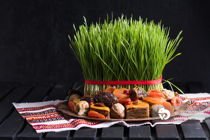 Novruz setting table decoration,  wheat grass, Azerbaijan national pastry pakhlava, new year sring celebration, nature awakening