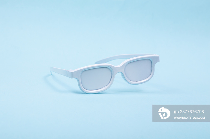 Levitating white glasses on blue background. 3D photo. Minimalistic still life. Creative layout. Concept art