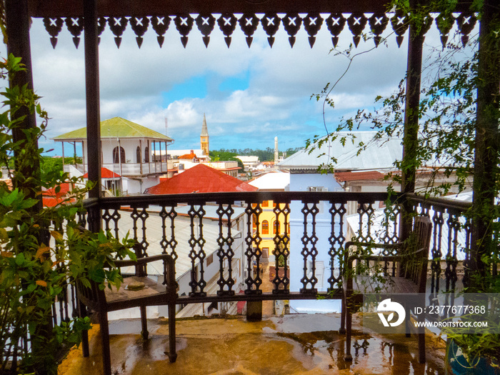 Stone Town, Zanzibar - Tanzania: A beautiful balcony with view over colourful rooftops on the historic old town