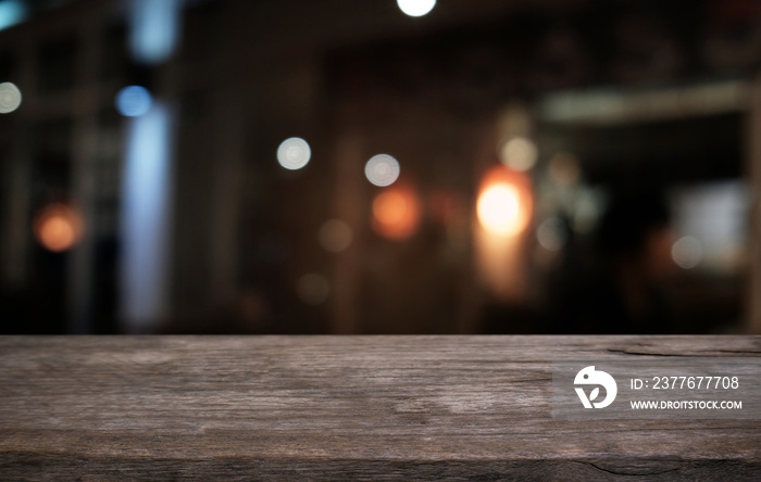 Empty dark wooden table in front of abstract blurred bokeh background of restaurant . can be used for display or montage your products.Mock up for space.