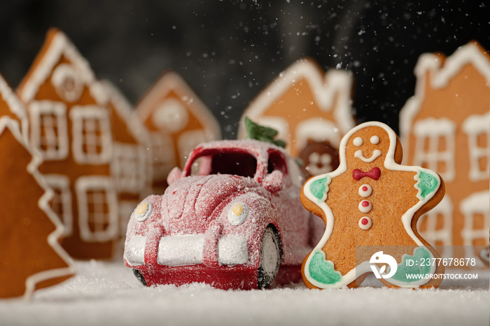 Christmas sweets toys. Frozen toy car with gingerbread man with gingerbread houses in background