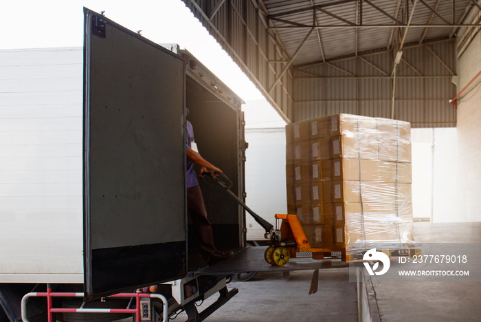 Workers Courier Unloading Packaging Boxes into Cargo Container. Delivery Trucks Shipment. Trucks Loading at Dock Warehouse. Supply Chain. Warehouse Shipping Transport and Logistics.