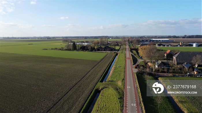 Farmland with farmer’s farm. Drone aerial view panarama sight. Winter with landscape resting for the new season. Farmers live with small villages in the area.