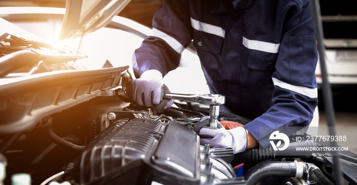 Auto mechanic working on car engine in mechanics garage.Repair service,car service, repair, maintenance concept.