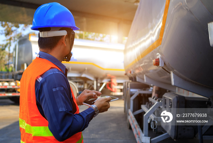 Truck drivers hand holding tablet checking the product list,Driver writing electronic log books,spot focus.