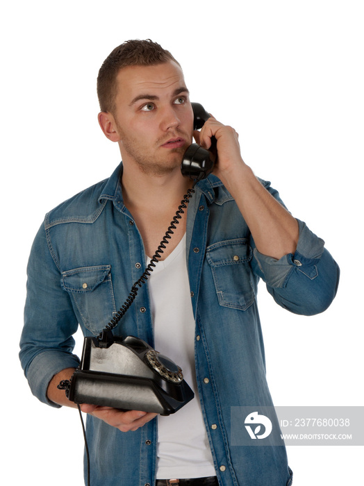 Young man making a phone call with an old telephone isolated on transparent background