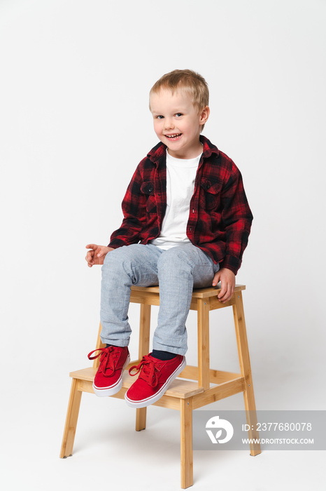 Portrait of a little smiling boy on white plain background - preschool kid