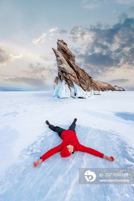 Happy woman tourist adventure landscape background blue ice cave and grotto winter from lake Baikal Russia sunset