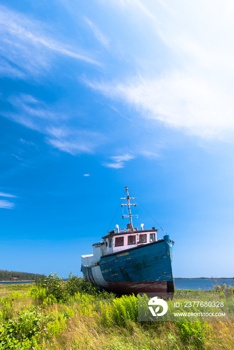 Landscape with an old wooden fishing boat on the ground, Nova Scotia, Canada.