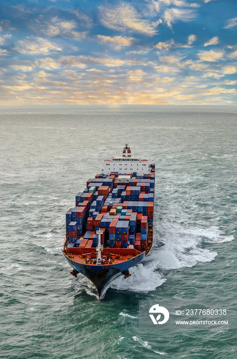 Nice aerial view of a giant container ship sailing at dawn in the English Channel