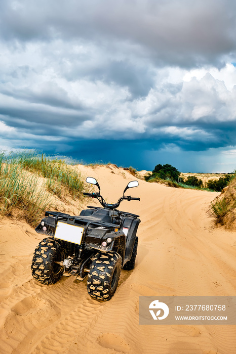 Quad bike on a sandy road.