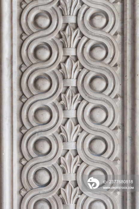 View of Massa, Tuscany - Italy. Ornamental bas-relief in marble on the cathedral’s entrance portal.