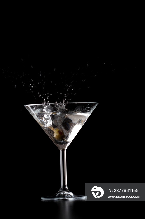 Splash in mrtini glass on black background