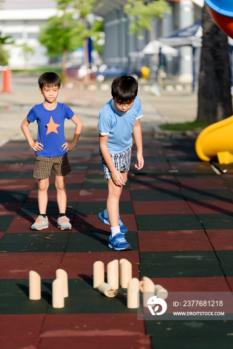 Young asian boy play with wooden toy number