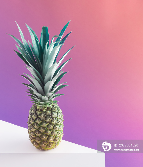 Fresh and ripe pineapple against purple pastel background. Concept art. Minimal surrealism background. Summer fruit gravity concept.