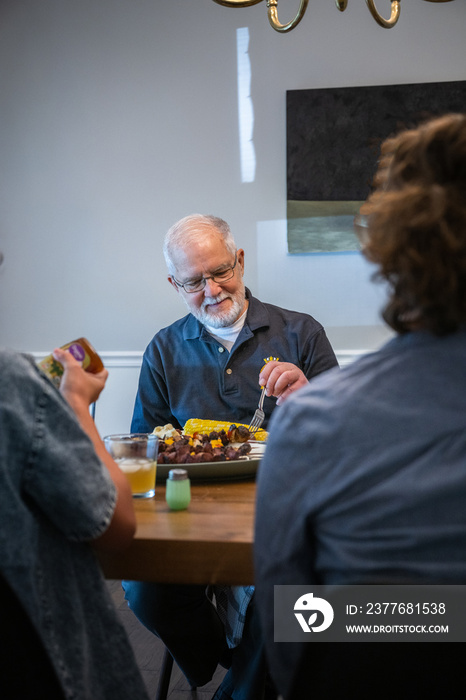 Air Force service member fixes and eats dinner with family.