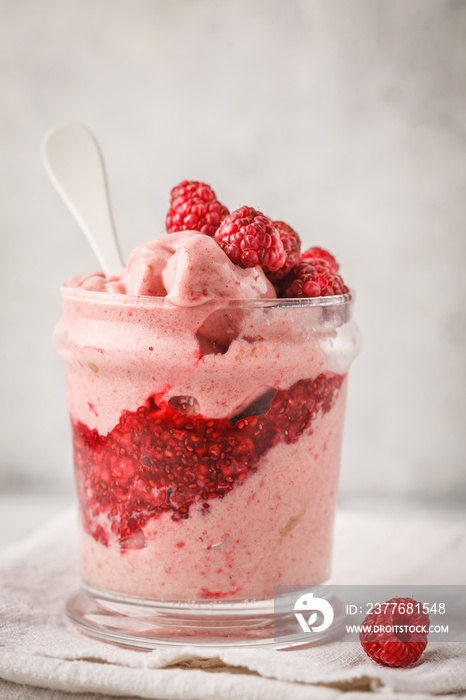 Vegan breakfast raspberry smoothie (ice cream) with berry jam in a jar.