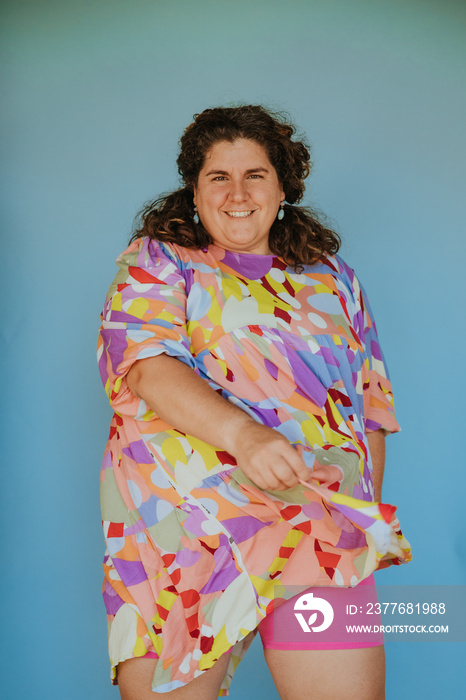 plus size woman on blue background showing bike shorts