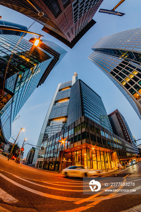 Low angle view of skyscrapers at night shot with a fish-eye lens