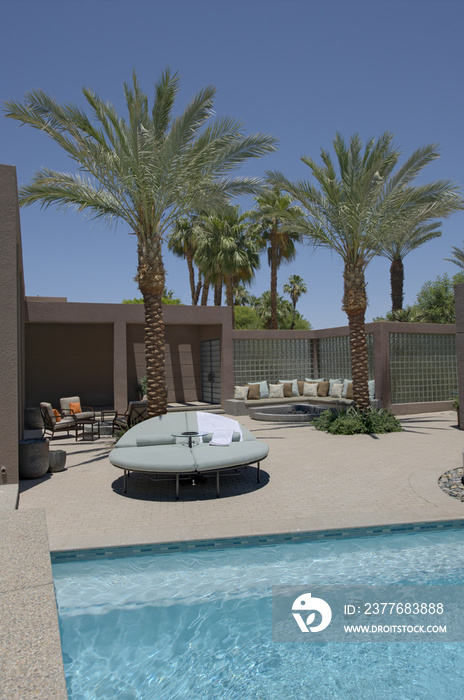 Seating with palm trees on poolside of Californian home