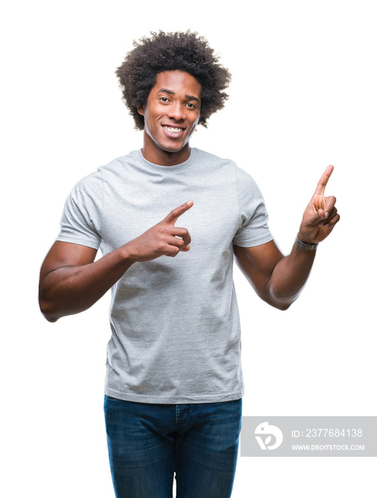 Afro american man over isolated background smiling and looking at the camera pointing with two hands and fingers to the side.