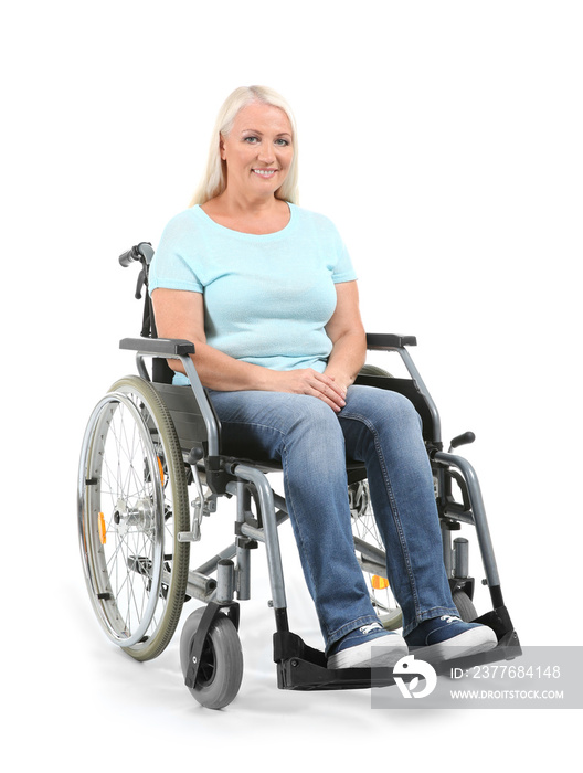 Mature woman sitting in wheelchair on white background