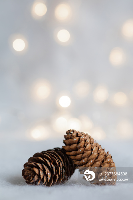 Christmas background with pine cones, snow and balls