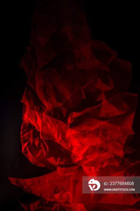 Dropping tissue papers flashed with red light